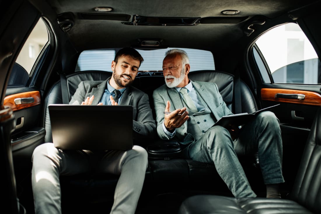 Two man sitting in limo for business meeting